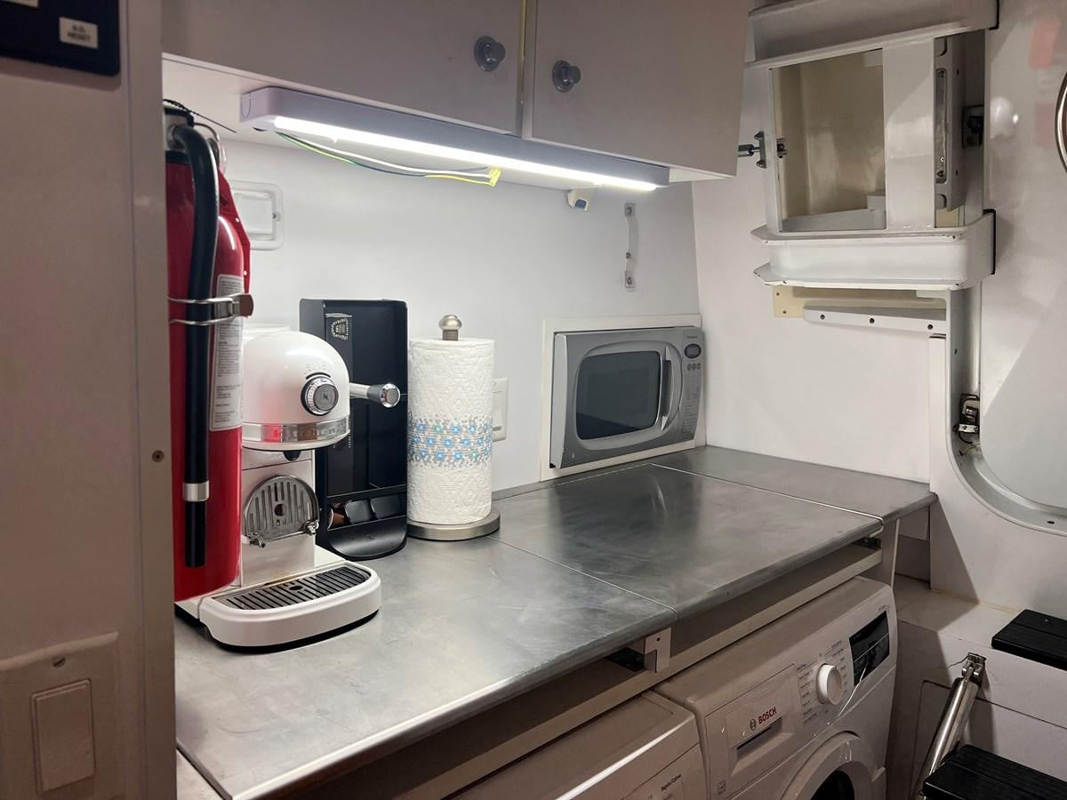 a kitchen with a coffee maker aboard ARETECTE Yacht for Sale