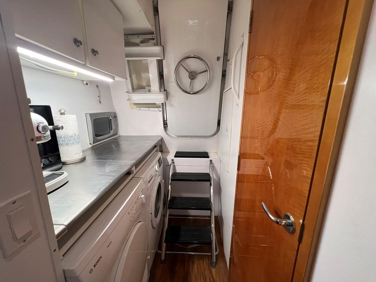a small kitchen with a small staircase aboard ARETECTE Yacht for Sale