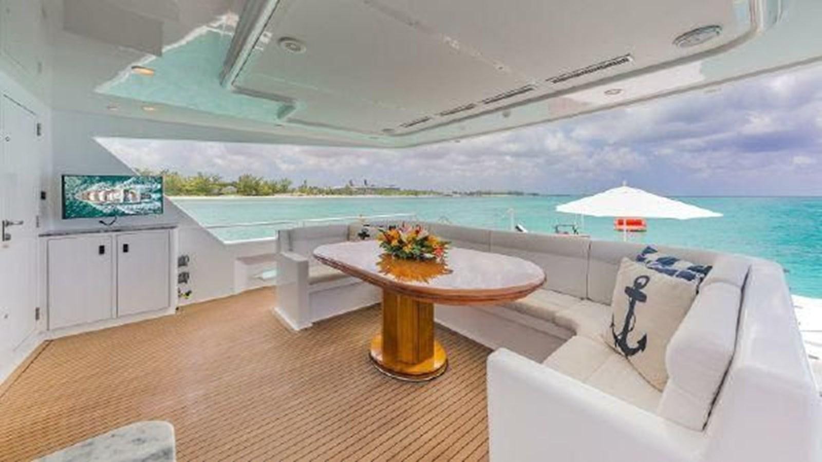 a room with a table and chairs aboard ROGUE Yacht for Sale