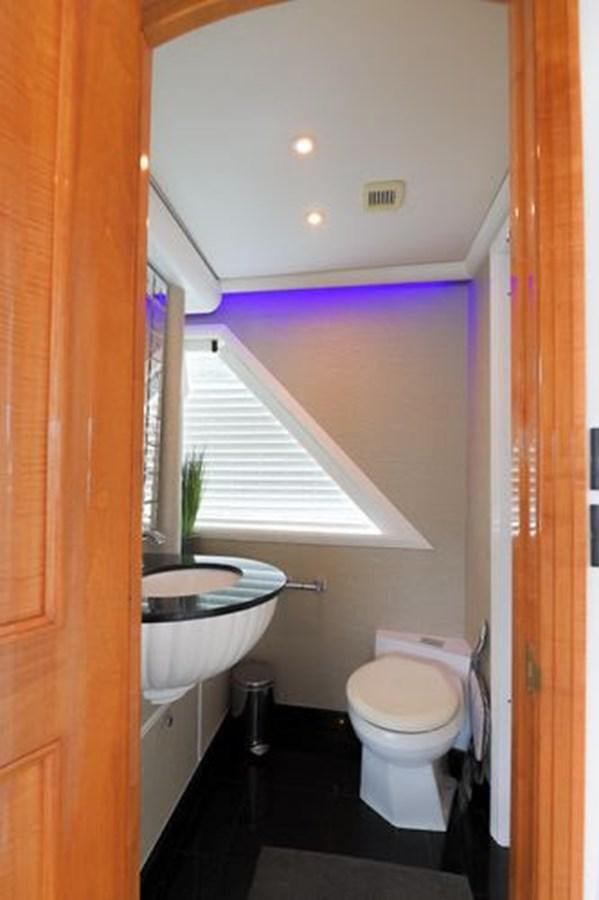 a small bathroom with a toilet and sink aboard ROGUE Yacht for Sale
