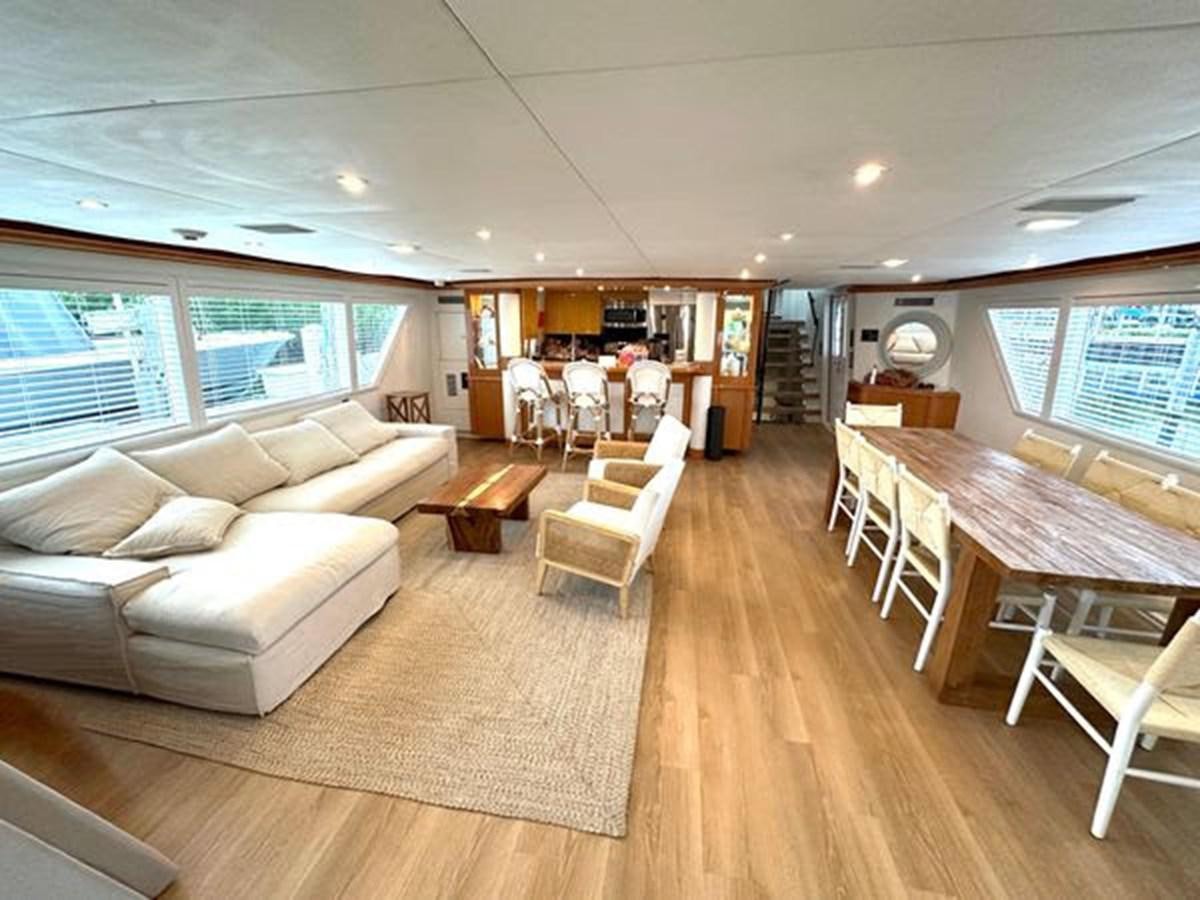 a living room with a wood floor aboard ROGUE Yacht for Sale