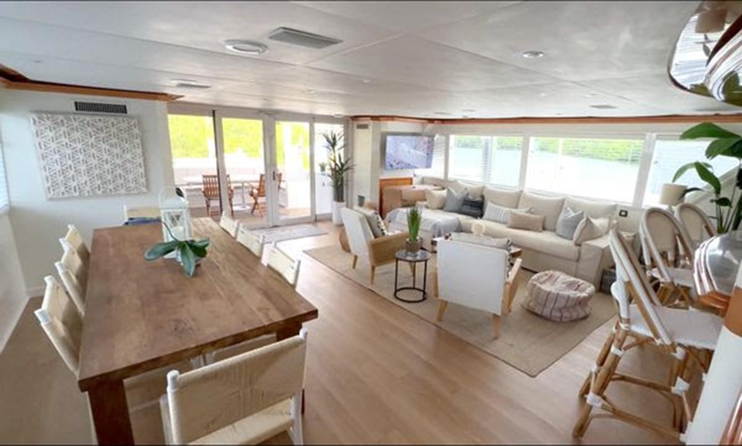 a living room with a table and chairs aboard ROGUE Yacht for Sale