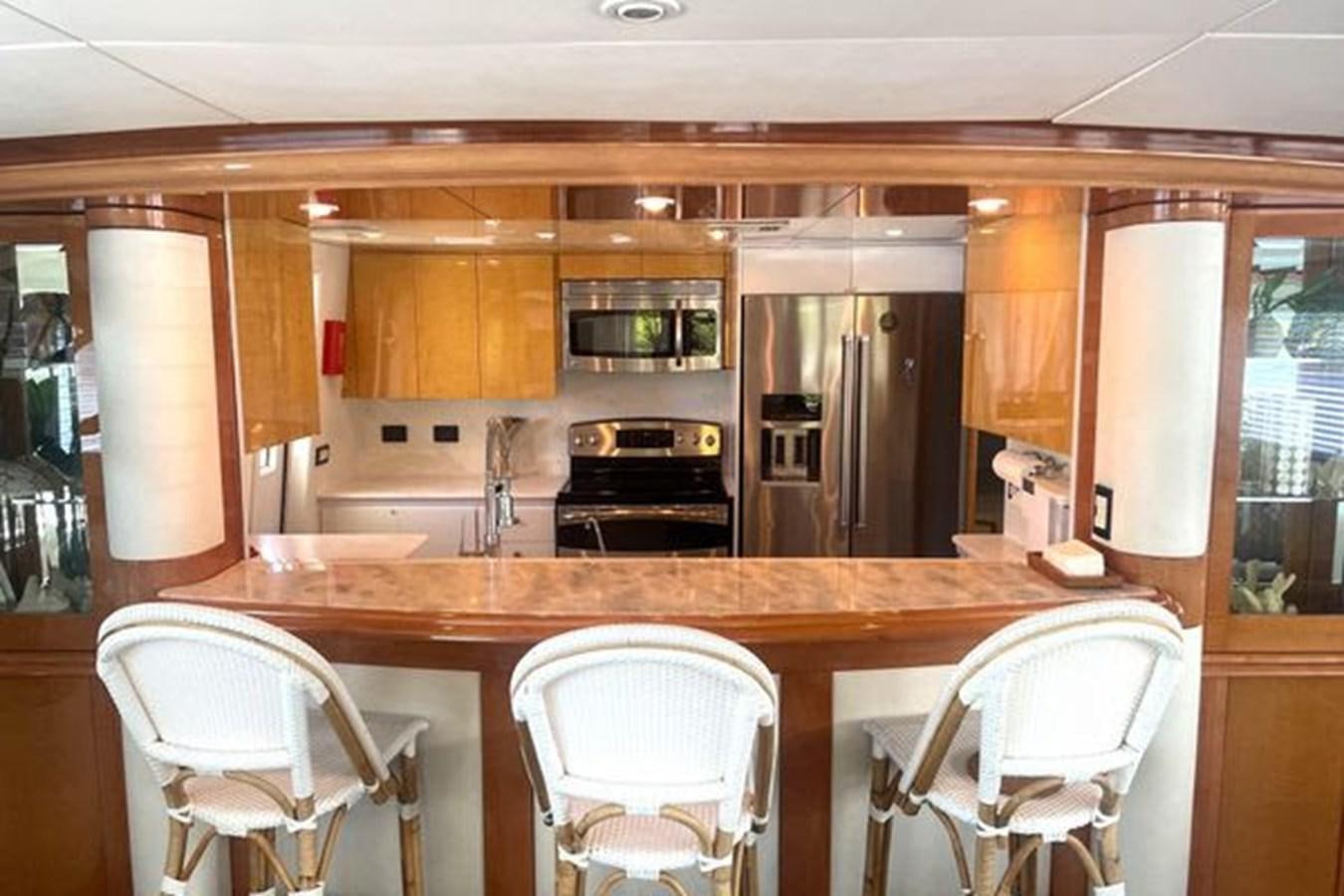 a kitchen with a table and chairs aboard ROGUE Yacht for Sale