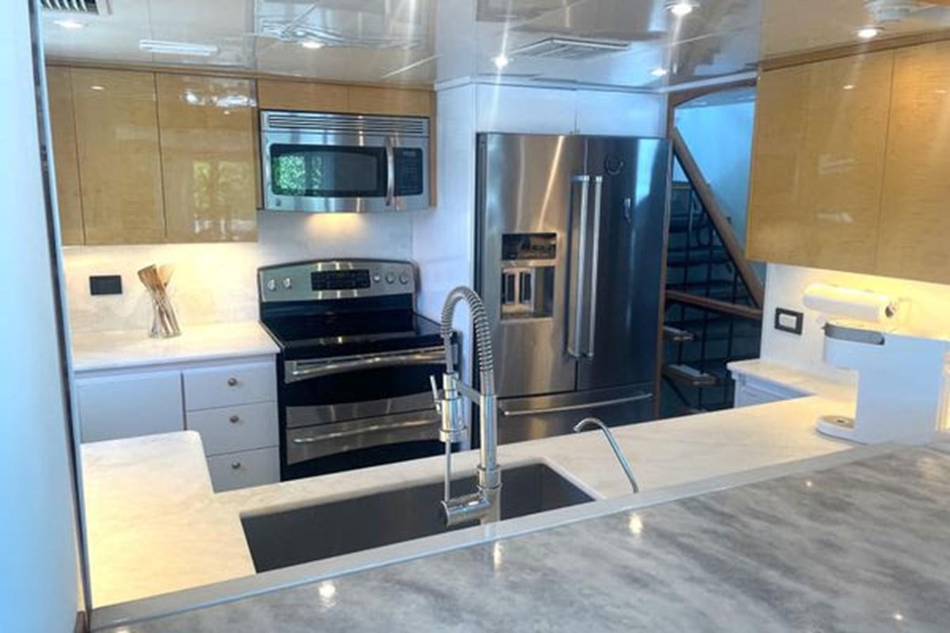 a kitchen with stainless steel appliances aboard ROGUE Yacht for Sale