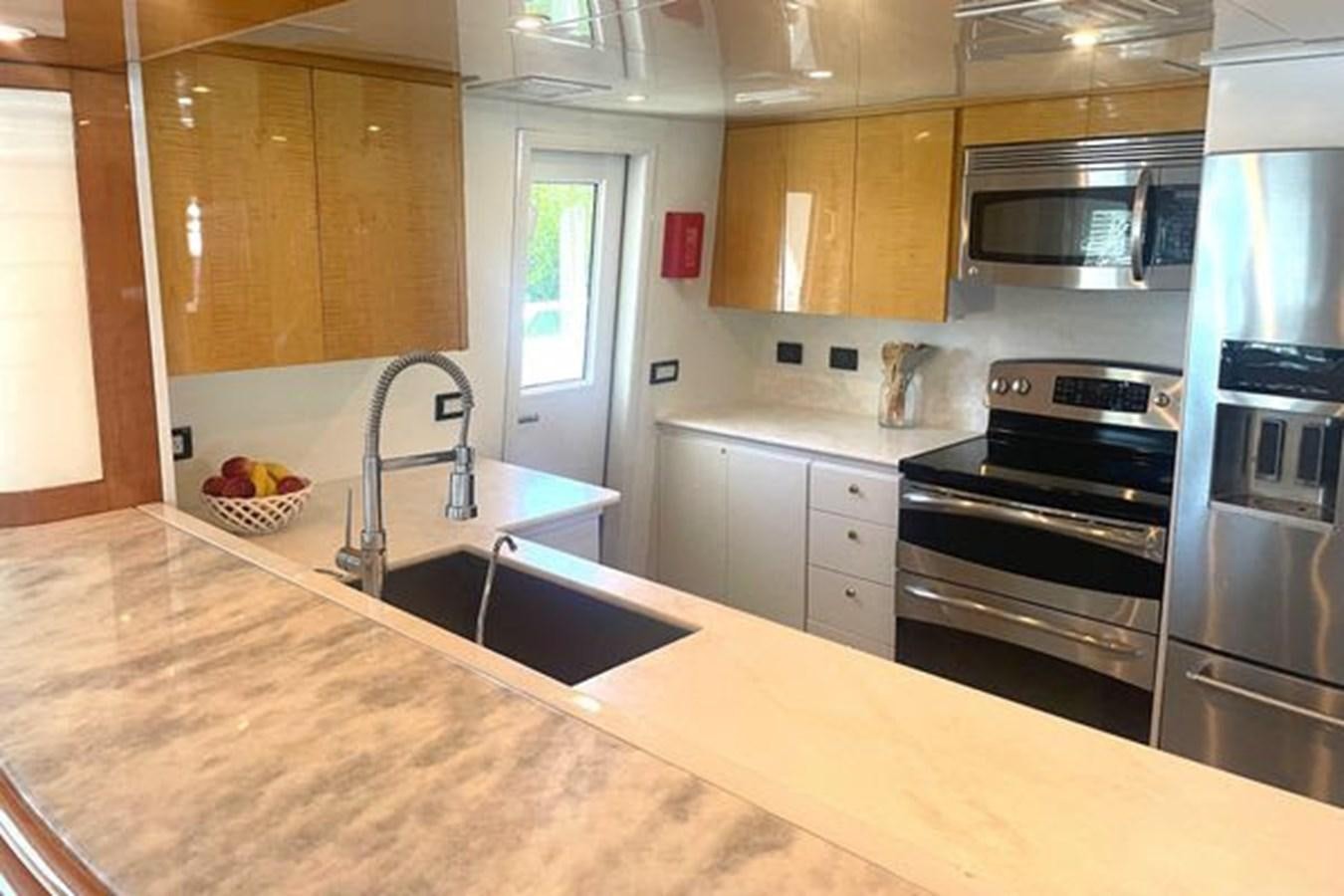 a kitchen with a stainless steel oven aboard ROGUE Yacht for Sale