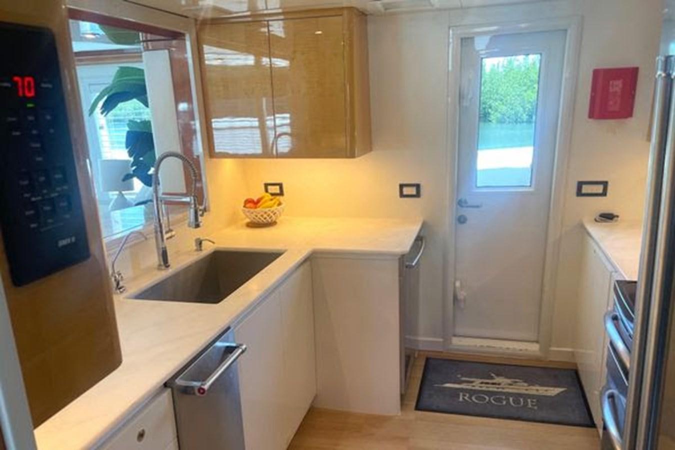 a kitchen with a sink and a door aboard ROGUE Yacht for Sale