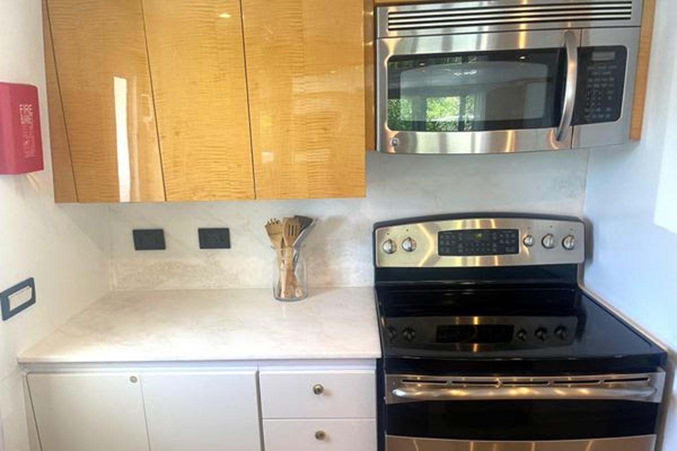 a kitchen with a microwave oven aboard ROGUE Yacht for Sale