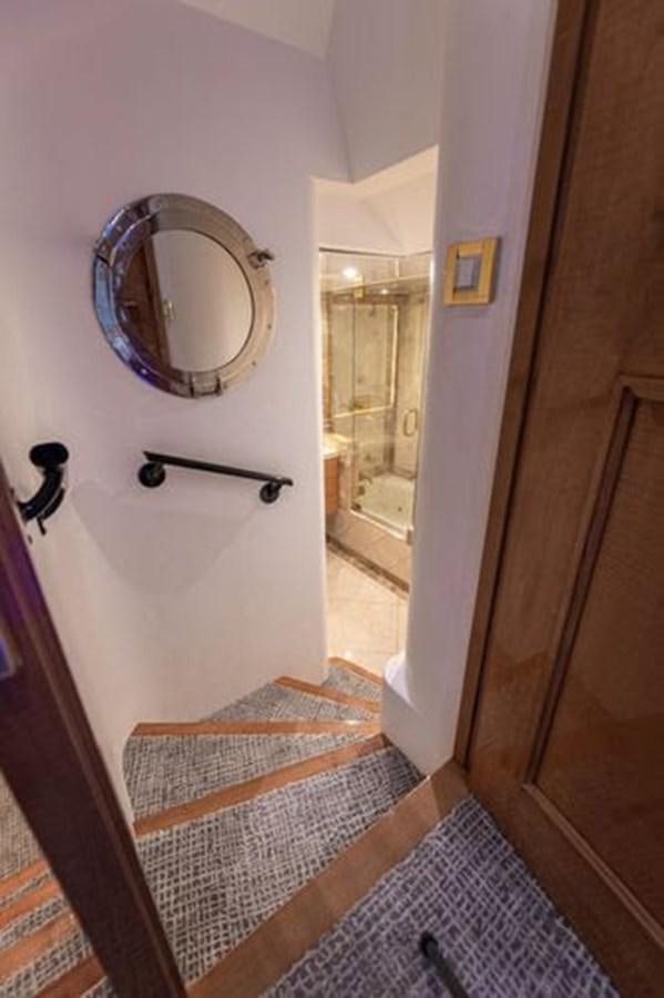 a bathroom with a round mirror aboard ROGUE Yacht for Sale