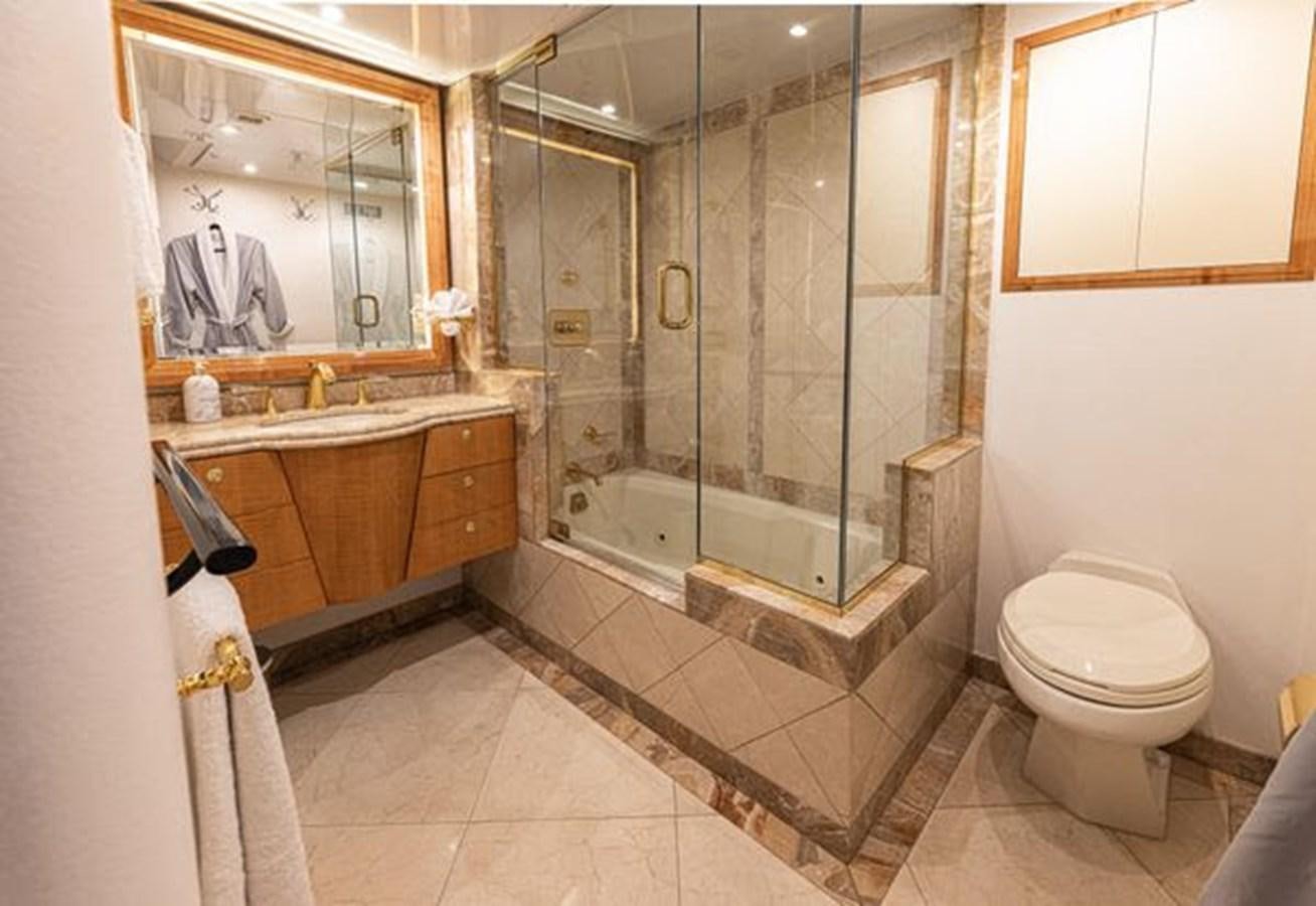 a bathroom with a glass shower aboard ROGUE Yacht for Sale