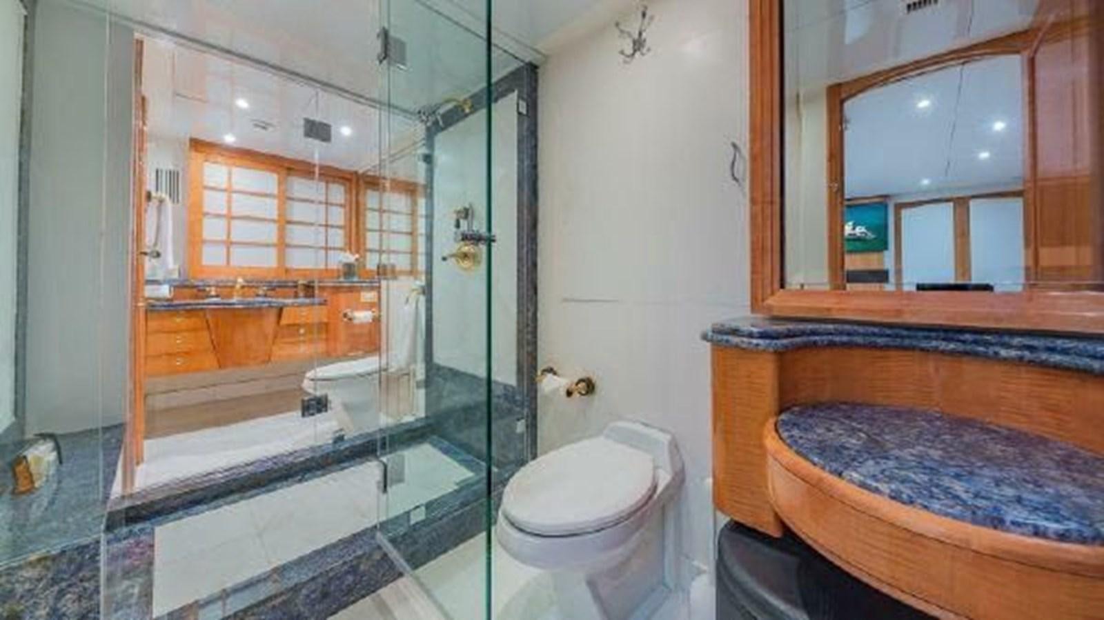 a bathroom with a glass shower aboard ROGUE Yacht for Sale