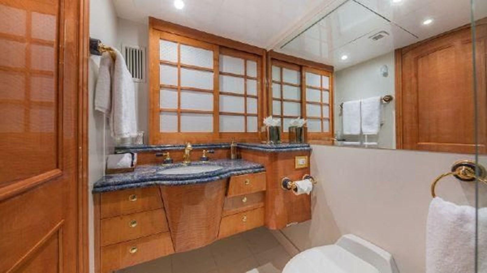 a bathroom with a large mirror aboard ROGUE Yacht for Sale
