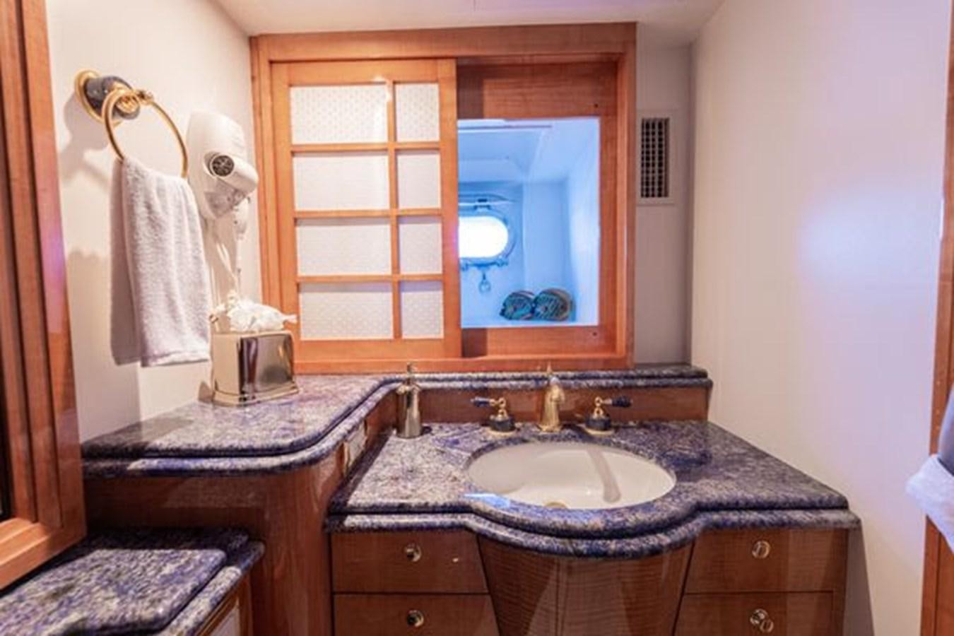 a bathroom with a sink and a mirror aboard ROGUE Yacht for Sale