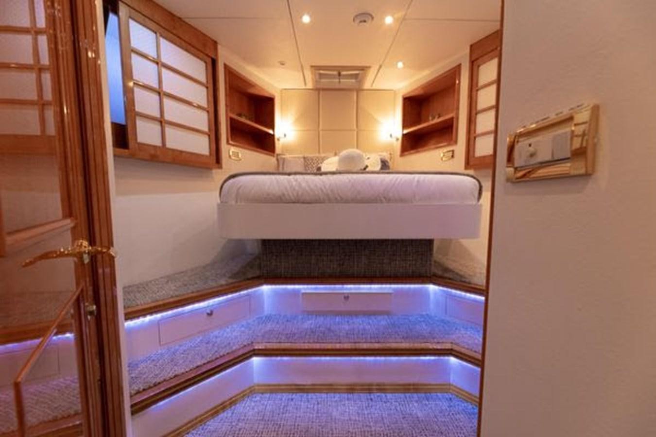 a bedroom with a bed and a closet aboard ROGUE Yacht for Sale