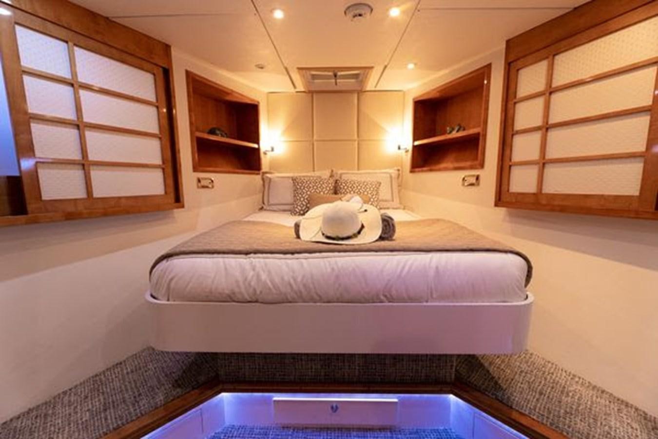 a large bedroom with a large bed aboard ROGUE Yacht for Sale