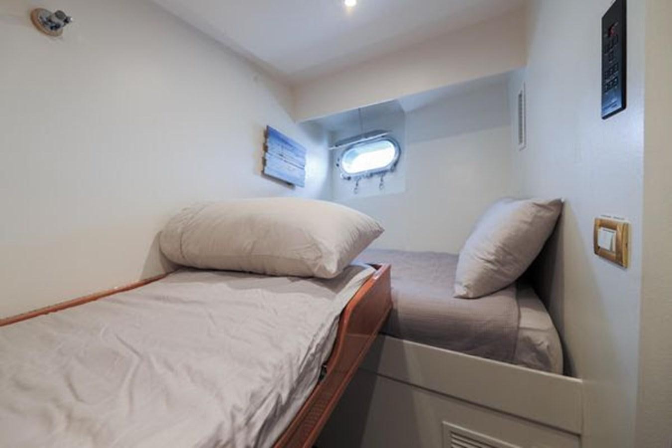 a room with two beds aboard ROGUE Yacht for Sale