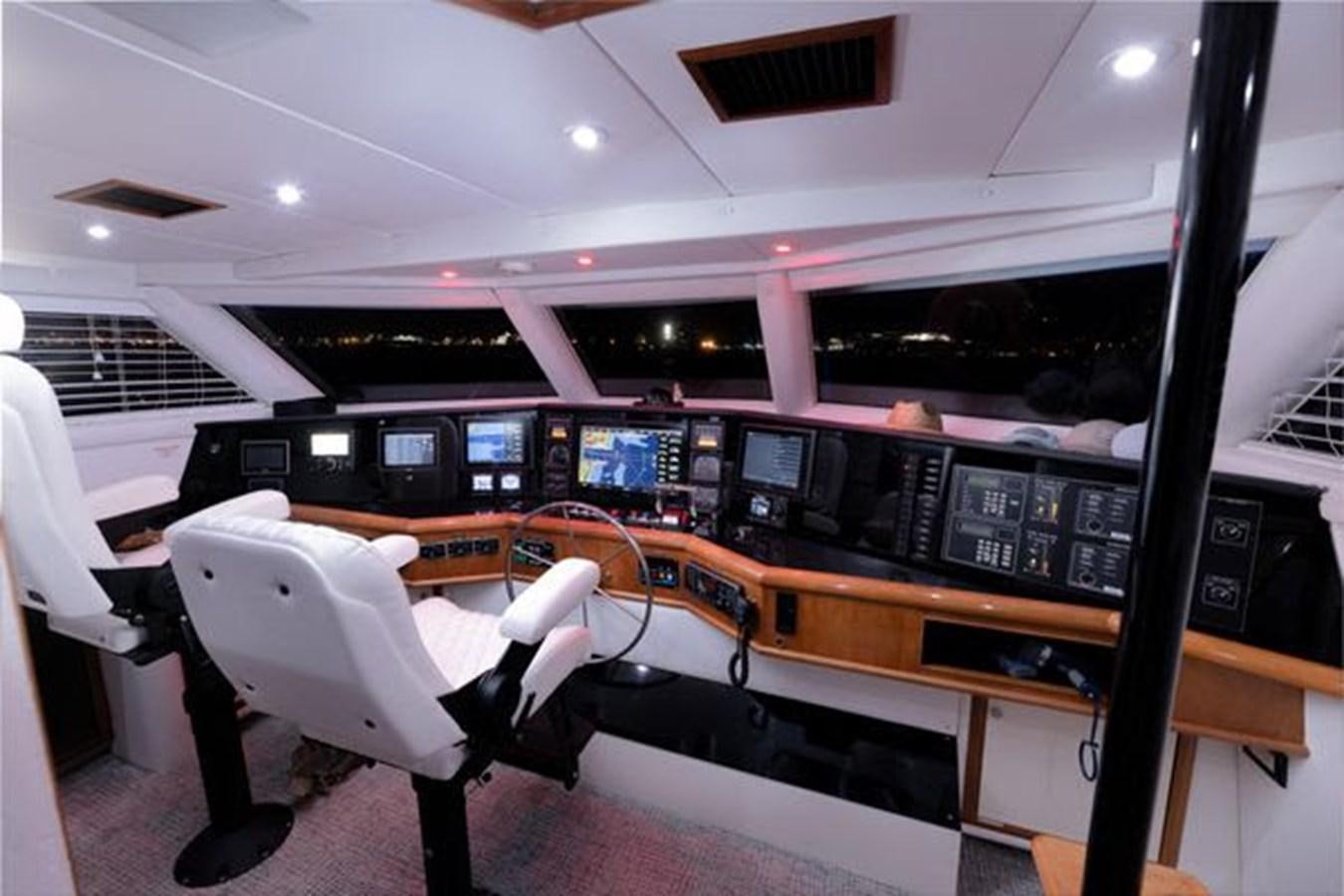 a room with computers and chairs aboard ROGUE Yacht for Sale