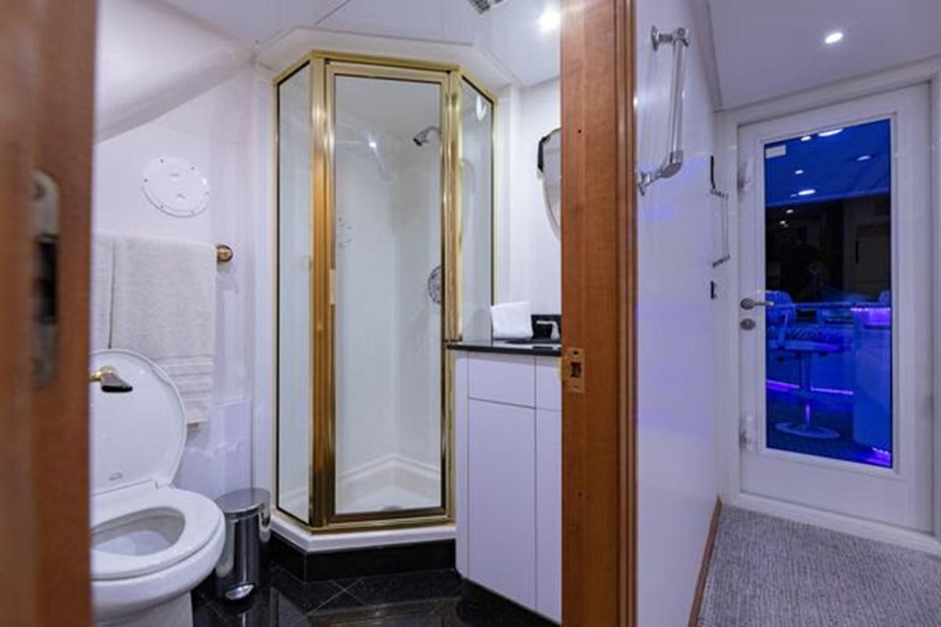 a bathroom with a glass door aboard ROGUE Yacht for Sale
