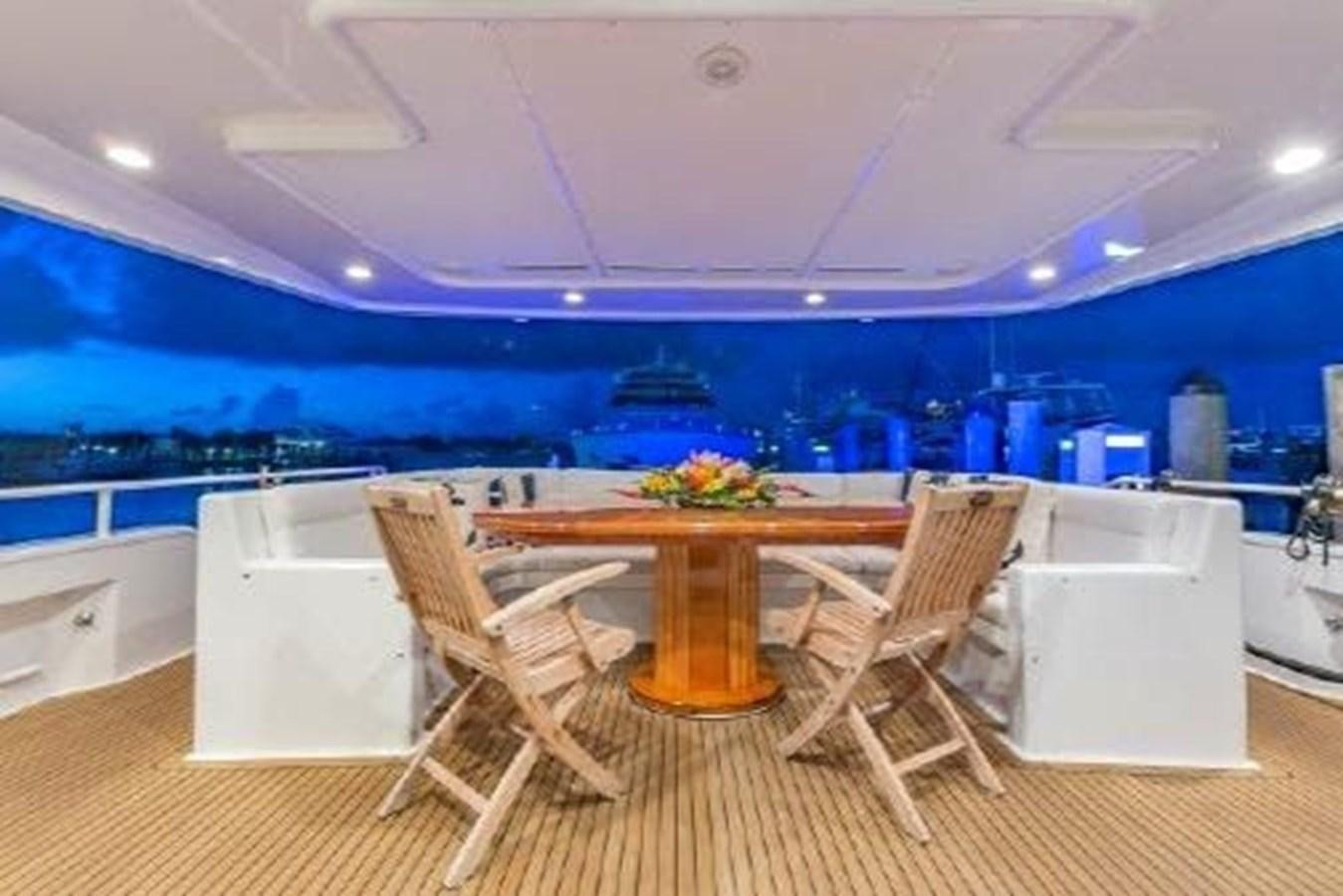 a room with a table and chairs aboard ROGUE Yacht for Sale