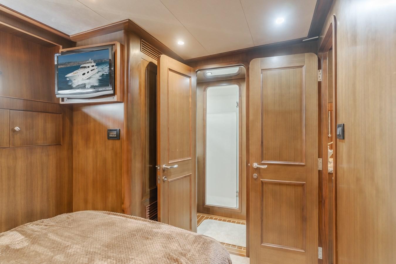 a room with a bed and a television aboard HARLEY G Yacht for Sale