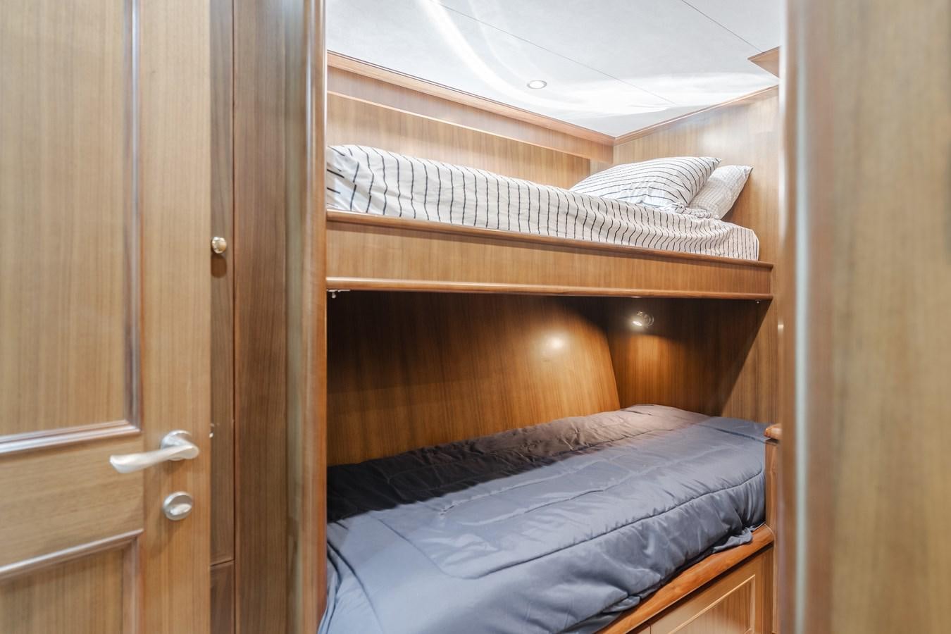 a bed with a wooden headboard aboard HARLEY G Yacht for Sale