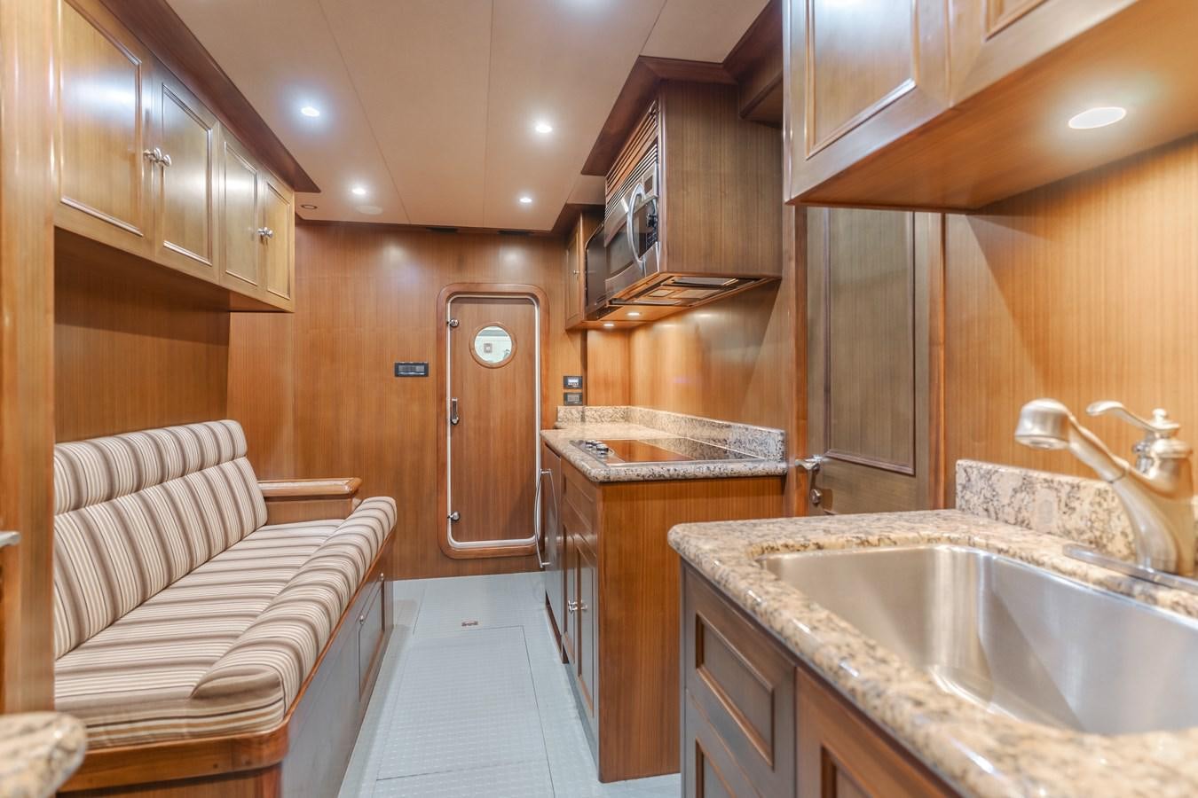 a kitchen with wooden cabinets aboard HARLEY G Yacht for Sale