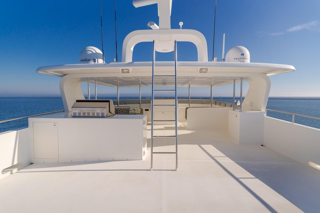 a white boat on a dock aboard HARLEY G Yacht for Sale