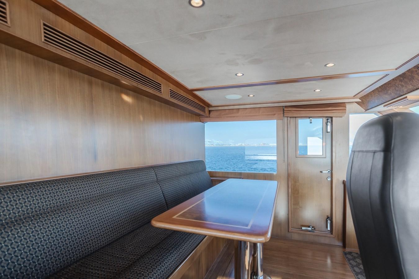 a room with a table and chairs aboard HARLEY G Yacht for Sale