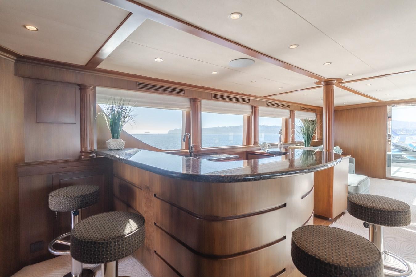 a kitchen with a bar and stools aboard HARLEY G Yacht for Sale