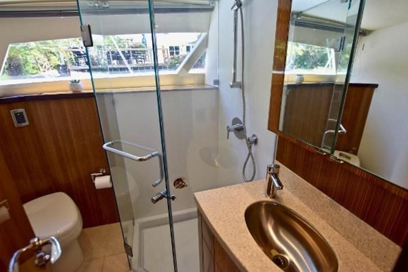 a bathroom with a sink and a shower aboard 2010 CUSTOM AXCELL  650 POWER CATAMARAN Yacht for Sale