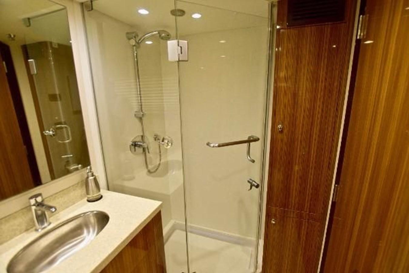 a bathroom with a shower and sink aboard 2010 CUSTOM AXCELL  650 POWER CATAMARAN Yacht for Sale