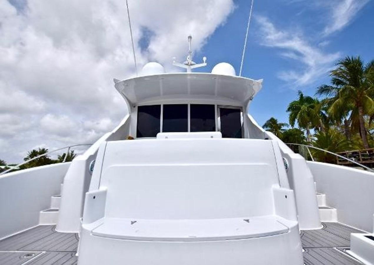 a white boat on a dock aboard 2010 CUSTOM AXCELL  650 POWER CATAMARAN Yacht for Sale