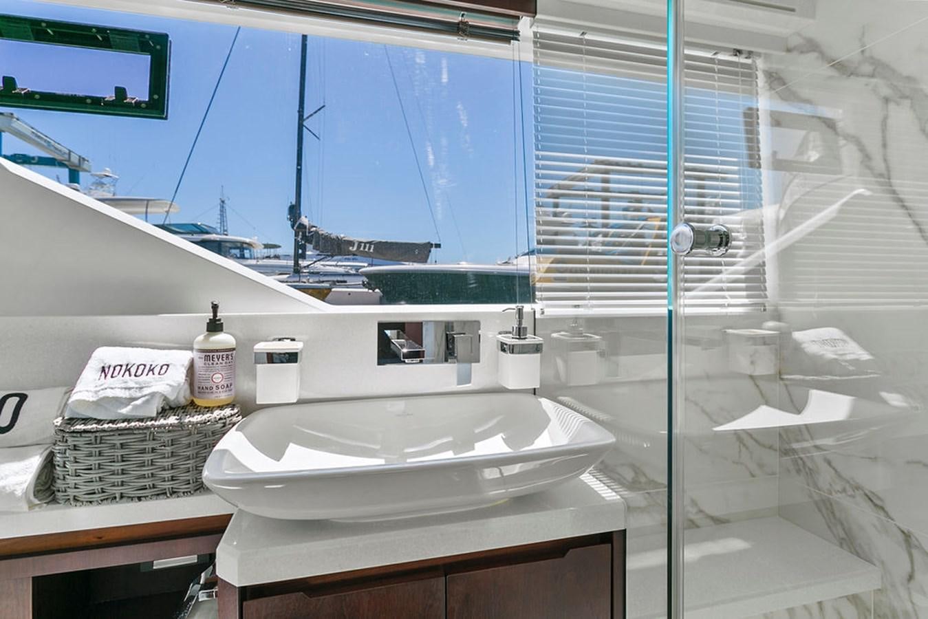 a bathroom with a sink and a shower aboard NOKOKO Yacht for Sale