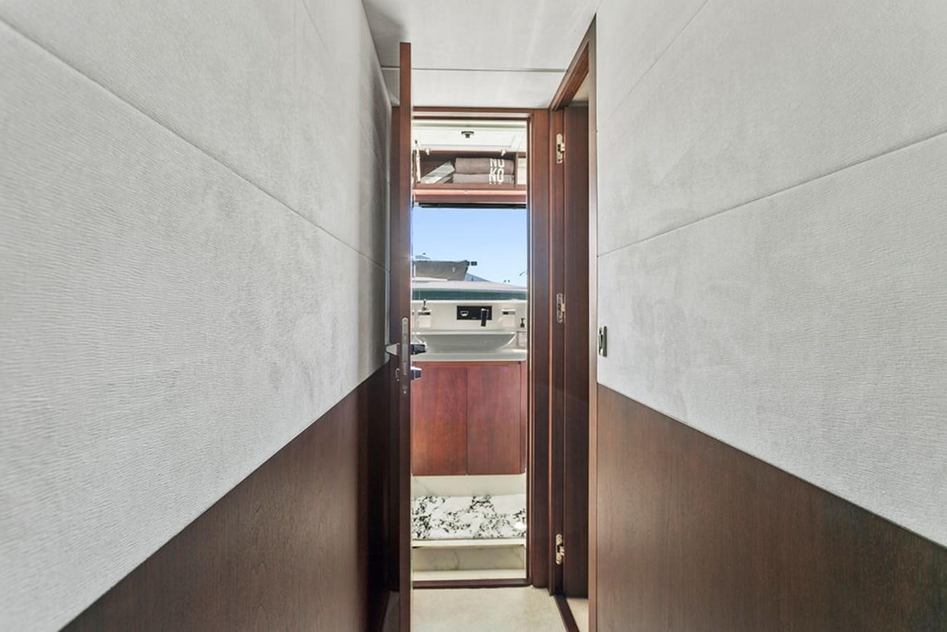 a hallway with a door and a balcony aboard NOKOKO Yacht for Sale