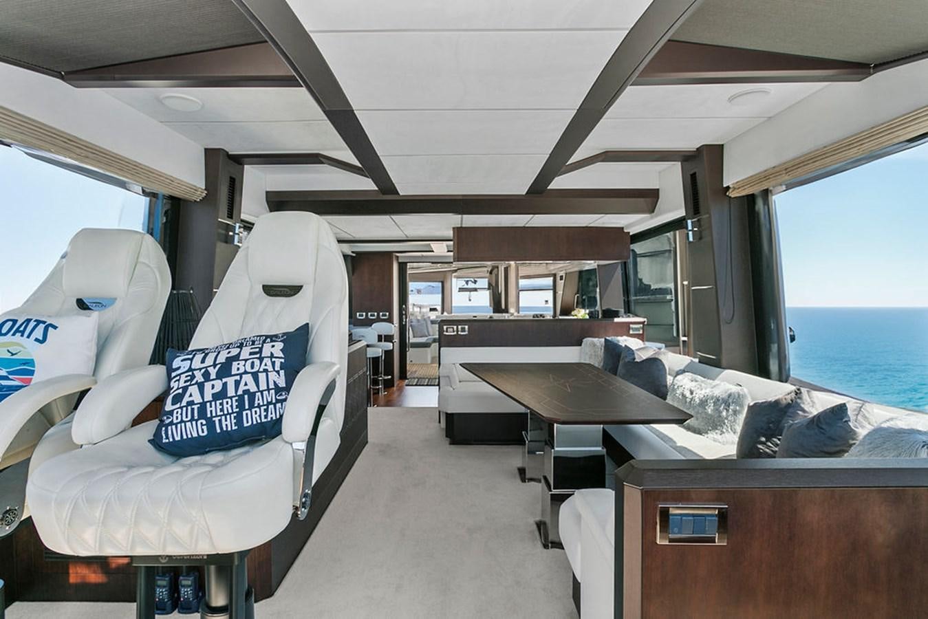 a room with a bed and desk aboard NOKOKO Yacht for Sale