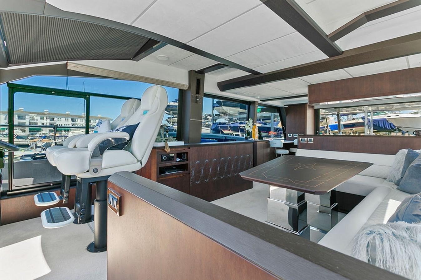 a room with a table and chairs aboard NOKOKO Yacht for Sale