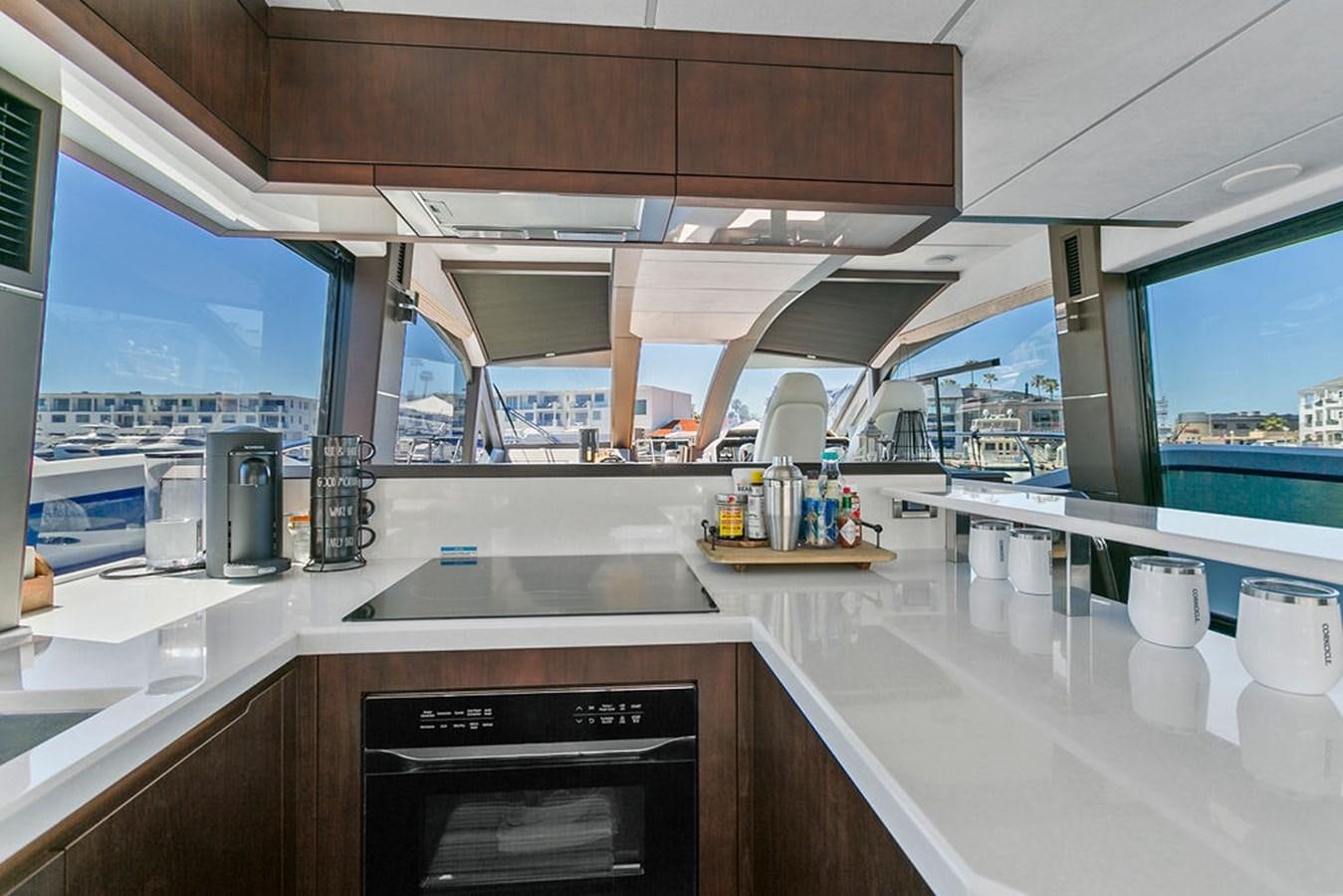 a kitchen with a large window aboard NOKOKO Yacht for Sale