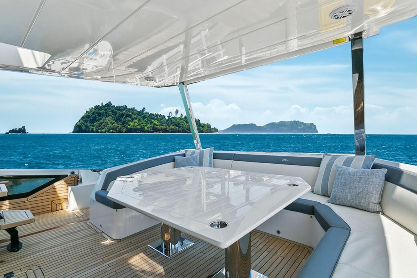 a table on a deck aboard NOKOKO Yacht for Sale