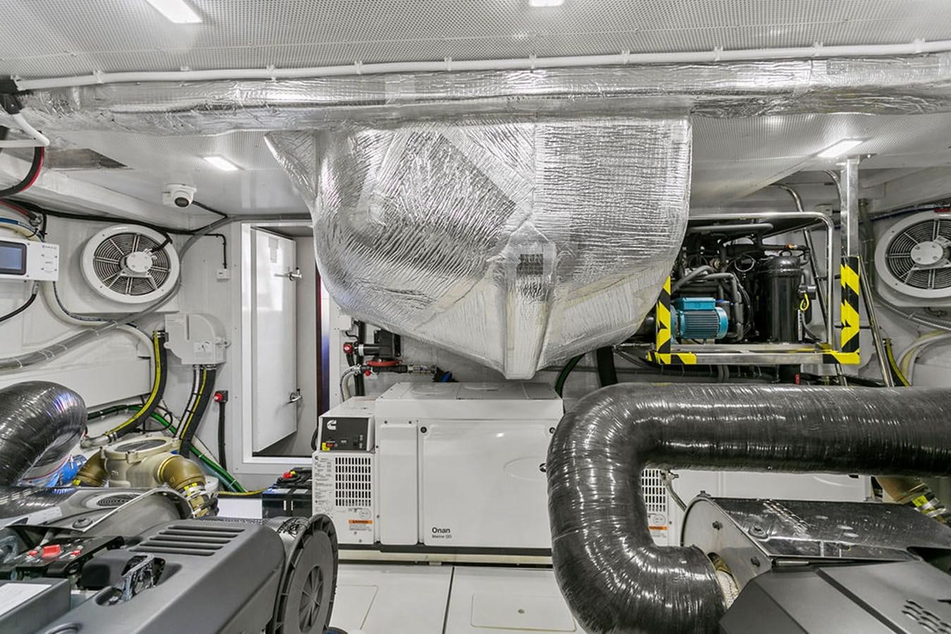 a large white machine with a large metal cylinder aboard NOKOKO Yacht for Sale