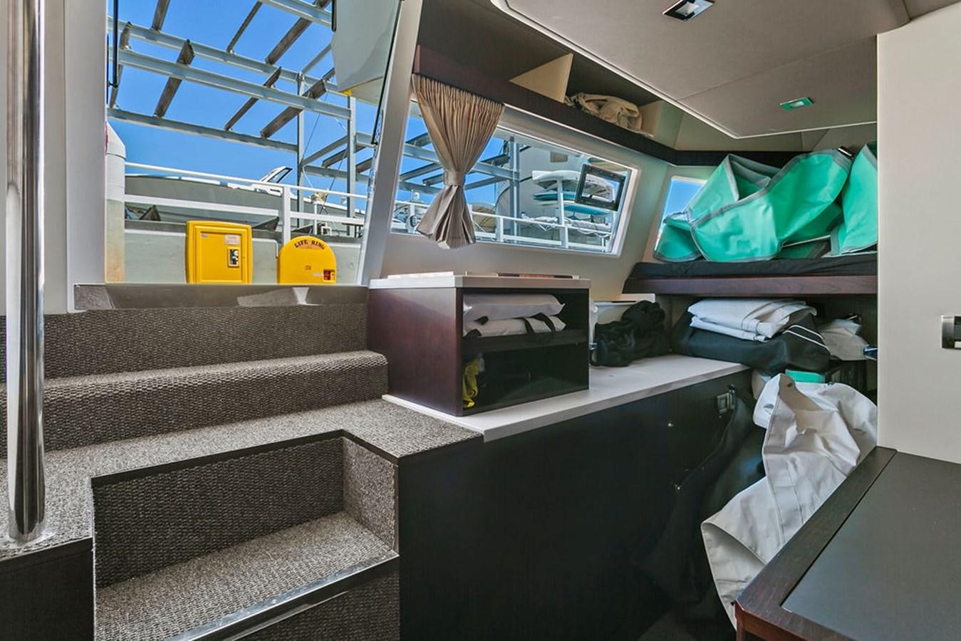 a room with shelves and a bed aboard NOKOKO Yacht for Sale