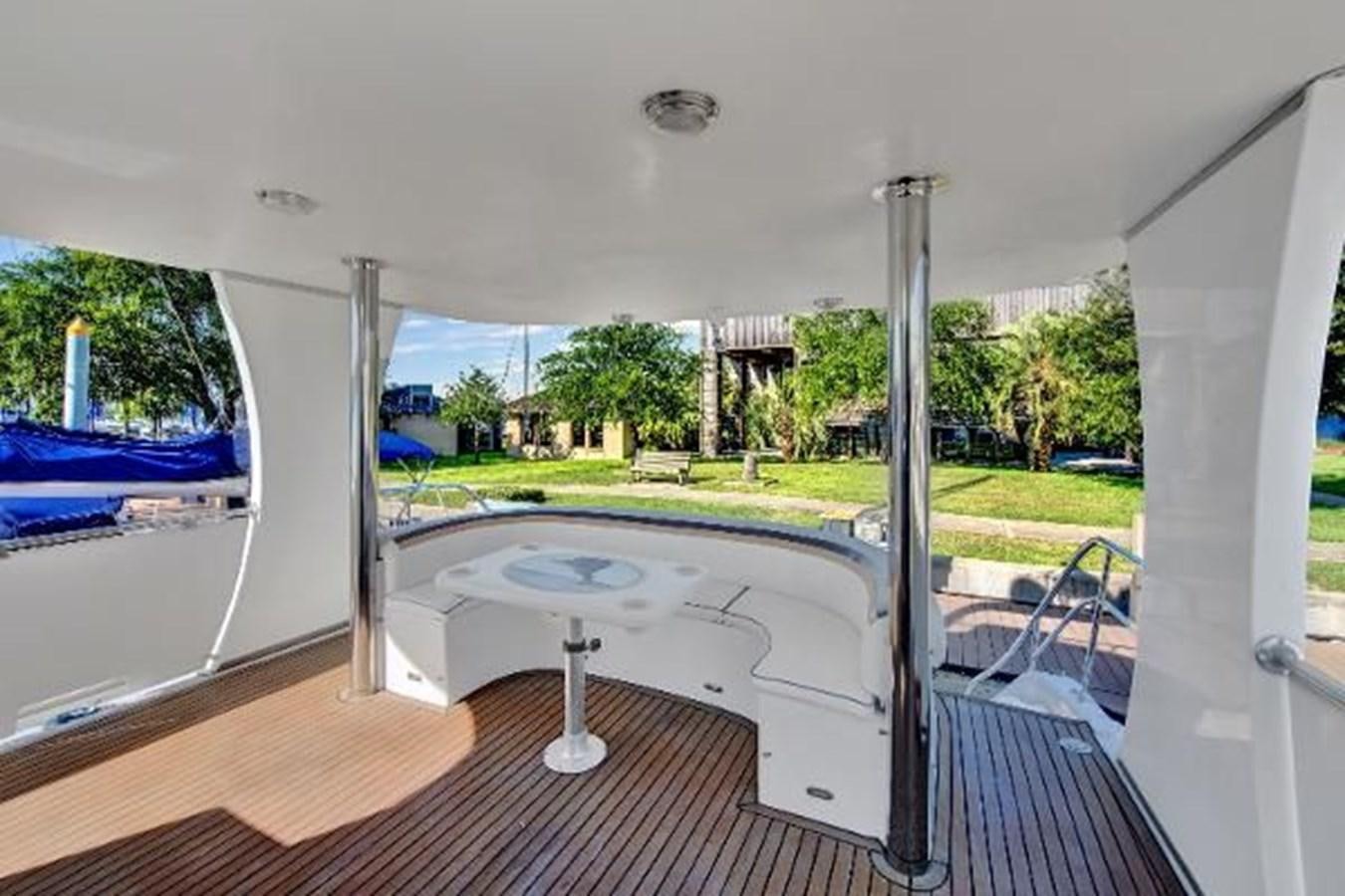 a large white window with a view of a pool and trees aboard DREAM CATCHER Yacht for Sale