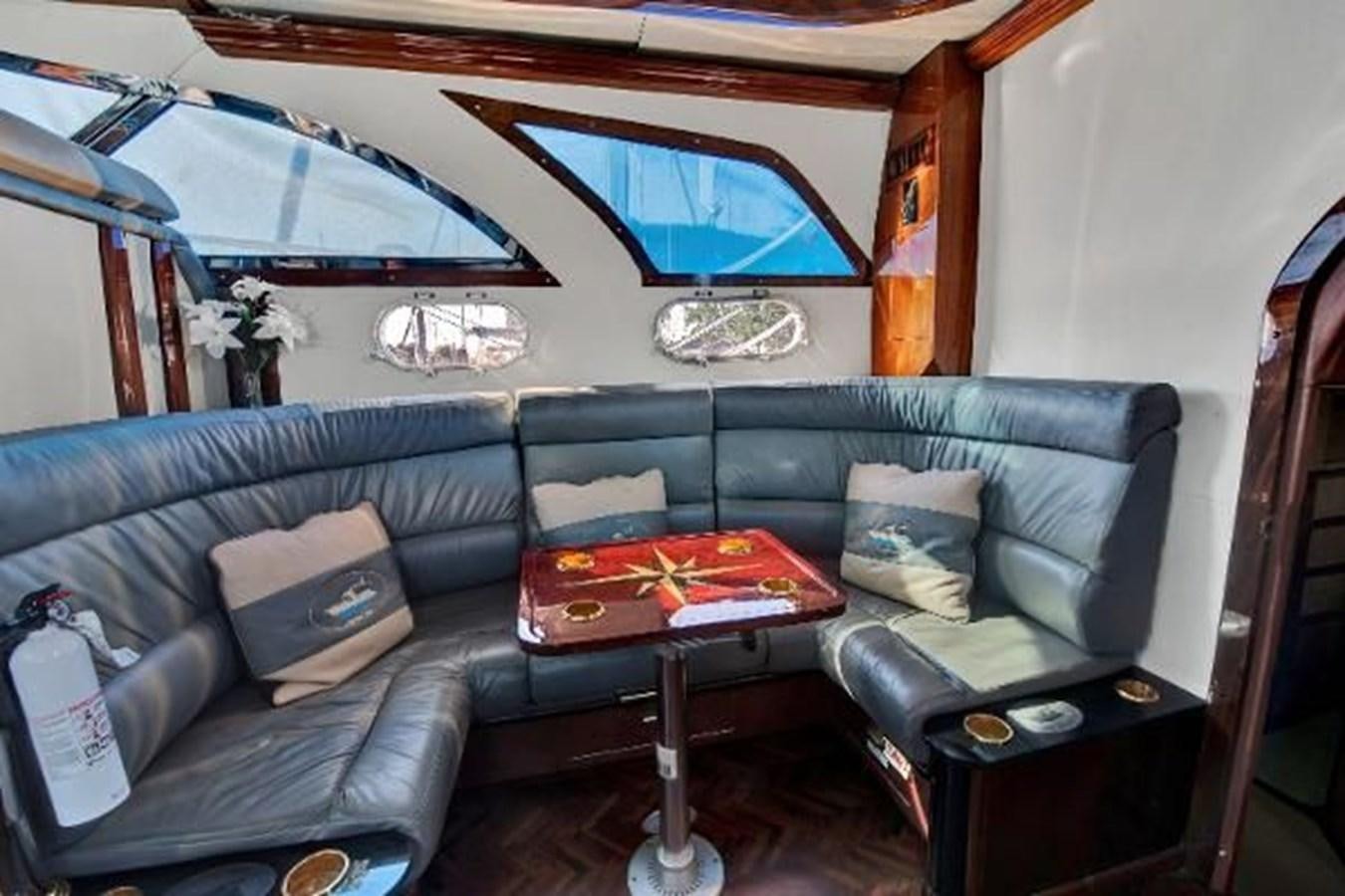 a living room with a couch and a table aboard DREAM CATCHER Yacht for Sale