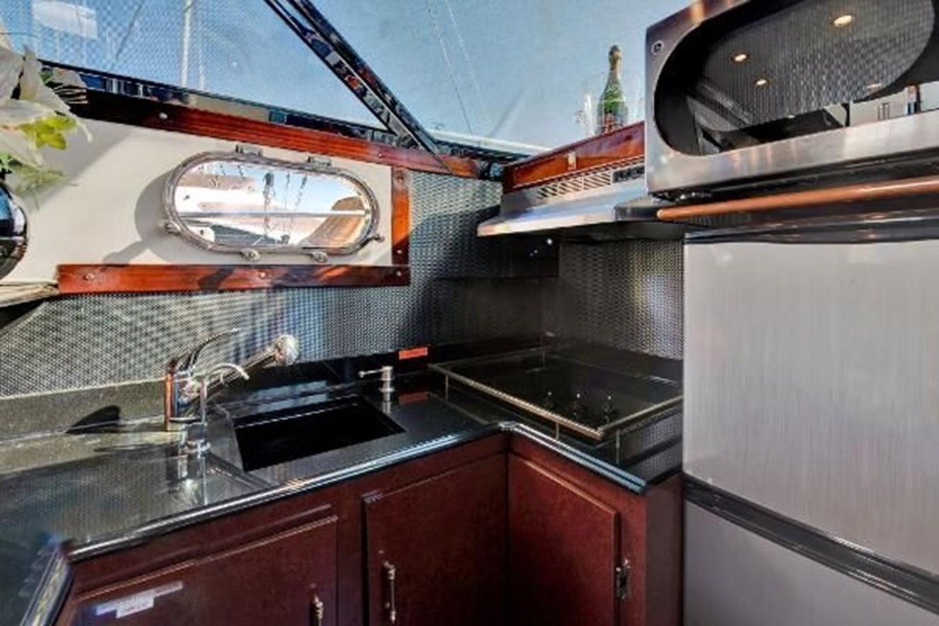 a kitchen with a sink and a microwave aboard DREAM CATCHER Yacht for Sale