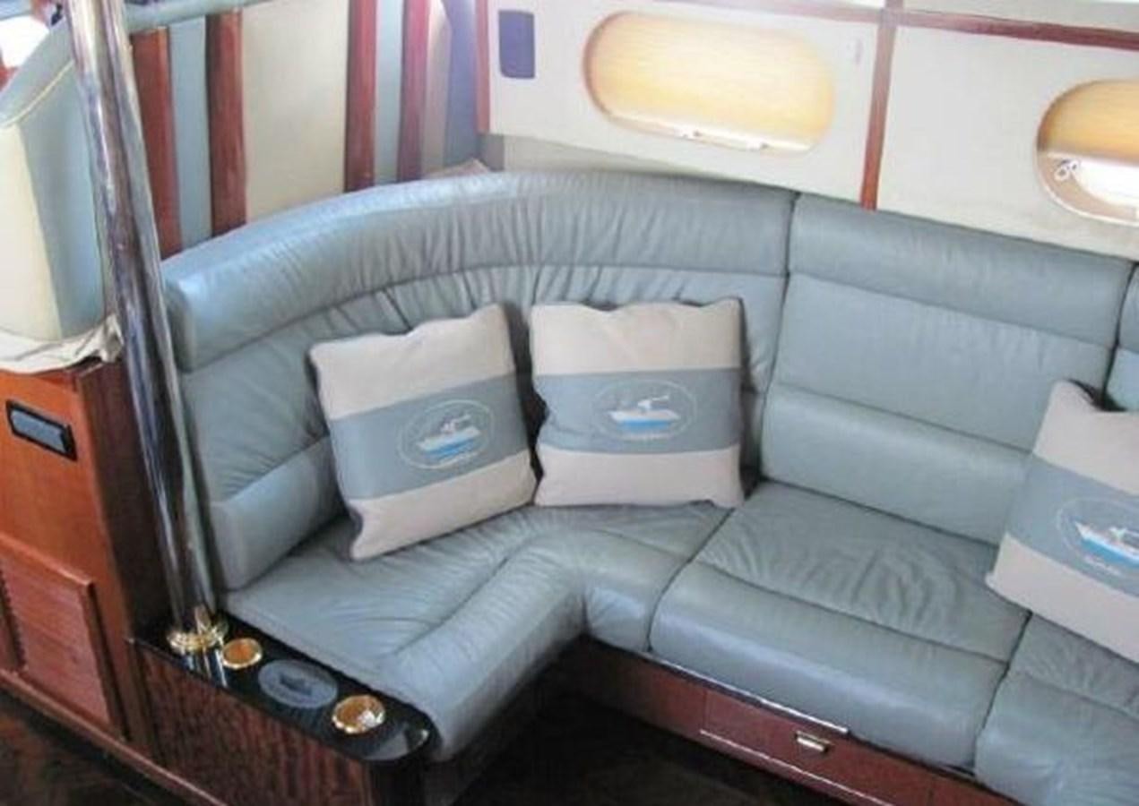a couch with a seat and pillows aboard DREAM CATCHER Yacht for Sale