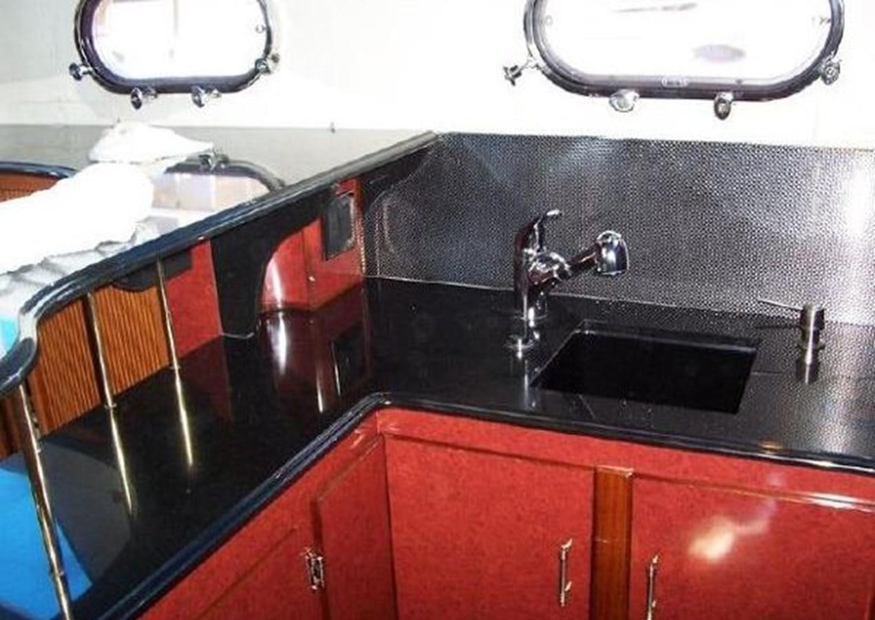 a kitchen with black counter tops aboard DREAM CATCHER Yacht for Sale