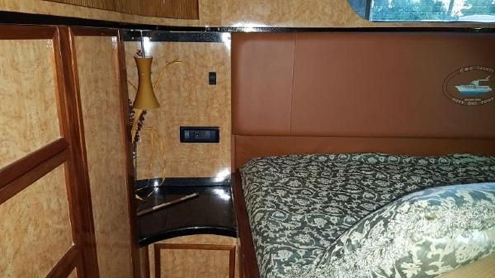 a bed with a lamp on it aboard DREAM CATCHER Yacht for Sale