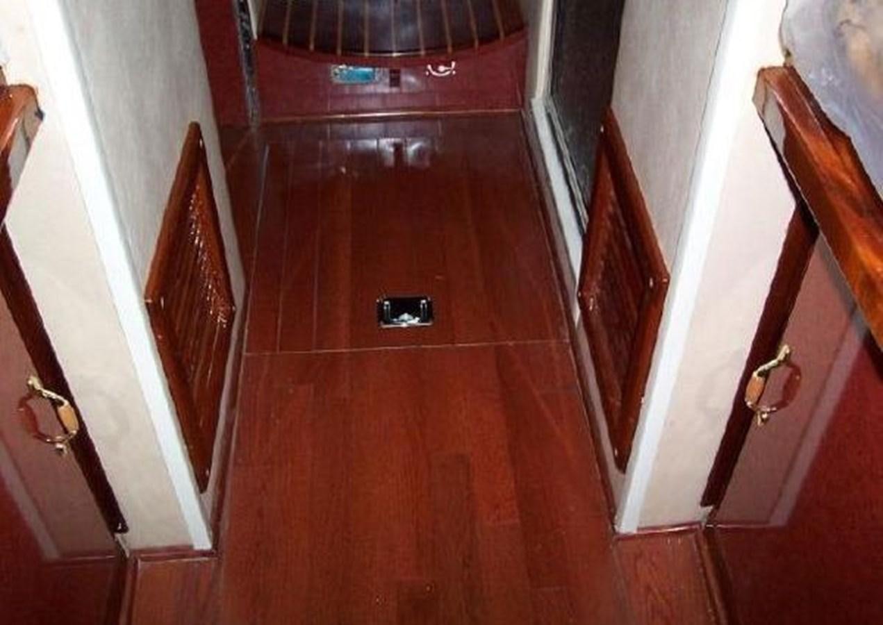 a room with a wood floor and a door with a window aboard DREAM CATCHER Yacht for Sale