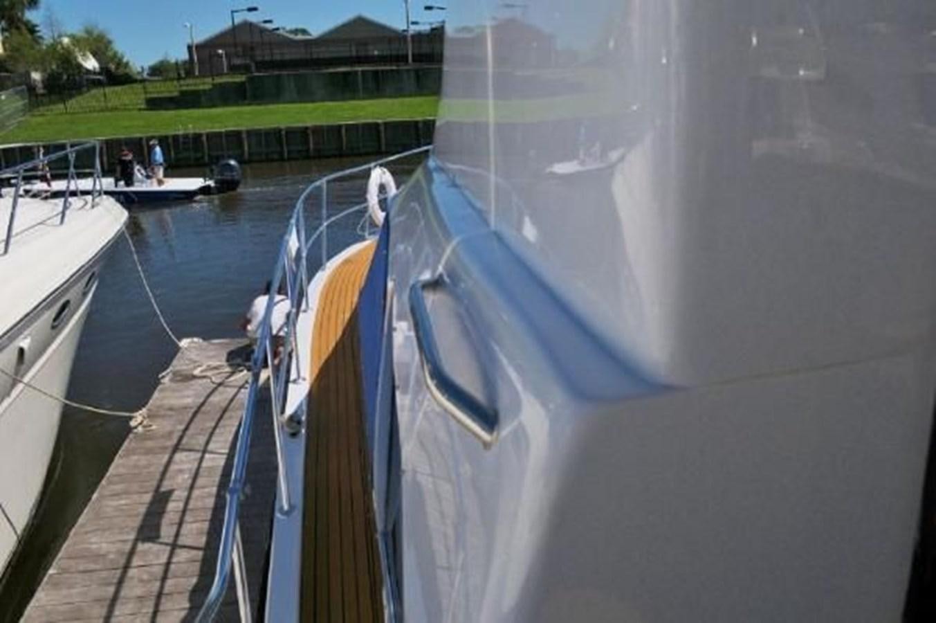 a boat with a yellow and white striped front aboard DREAM CATCHER Yacht for Sale