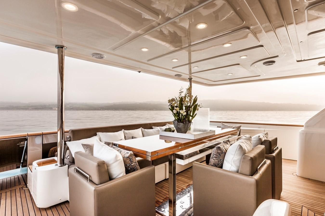 a room with a couch and a table and a large window aboard YVONNE Yacht for Sale
