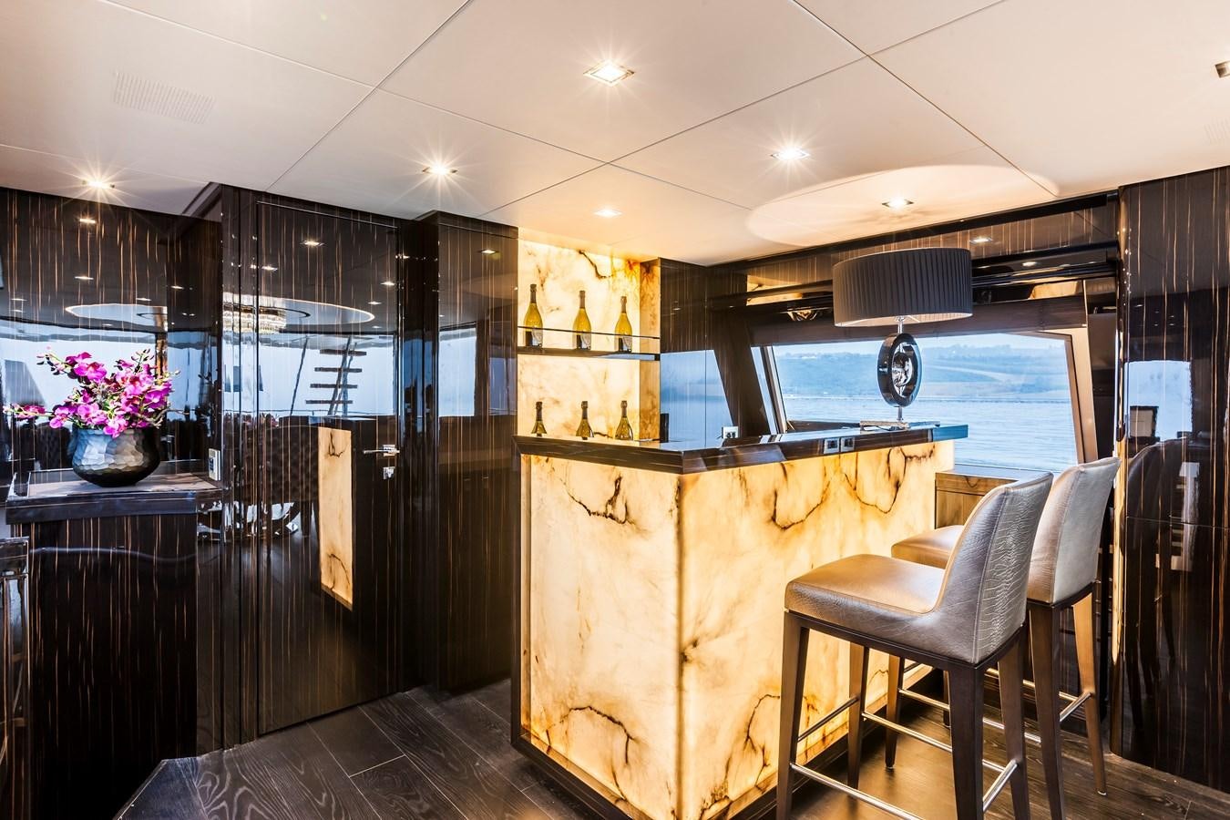 a kitchen with a bar and a table aboard YVONNE Yacht for Sale
