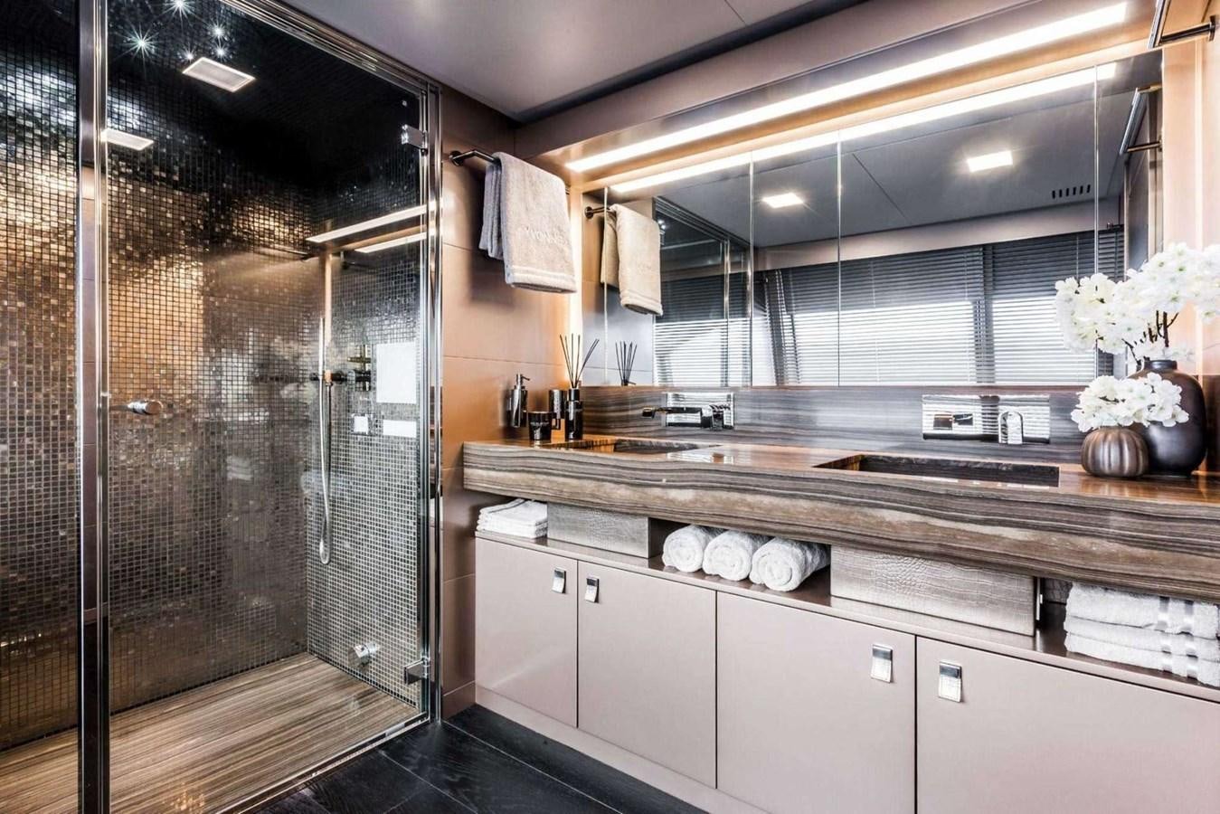 a bathroom with a glass shower aboard YVONNE Yacht for Sale